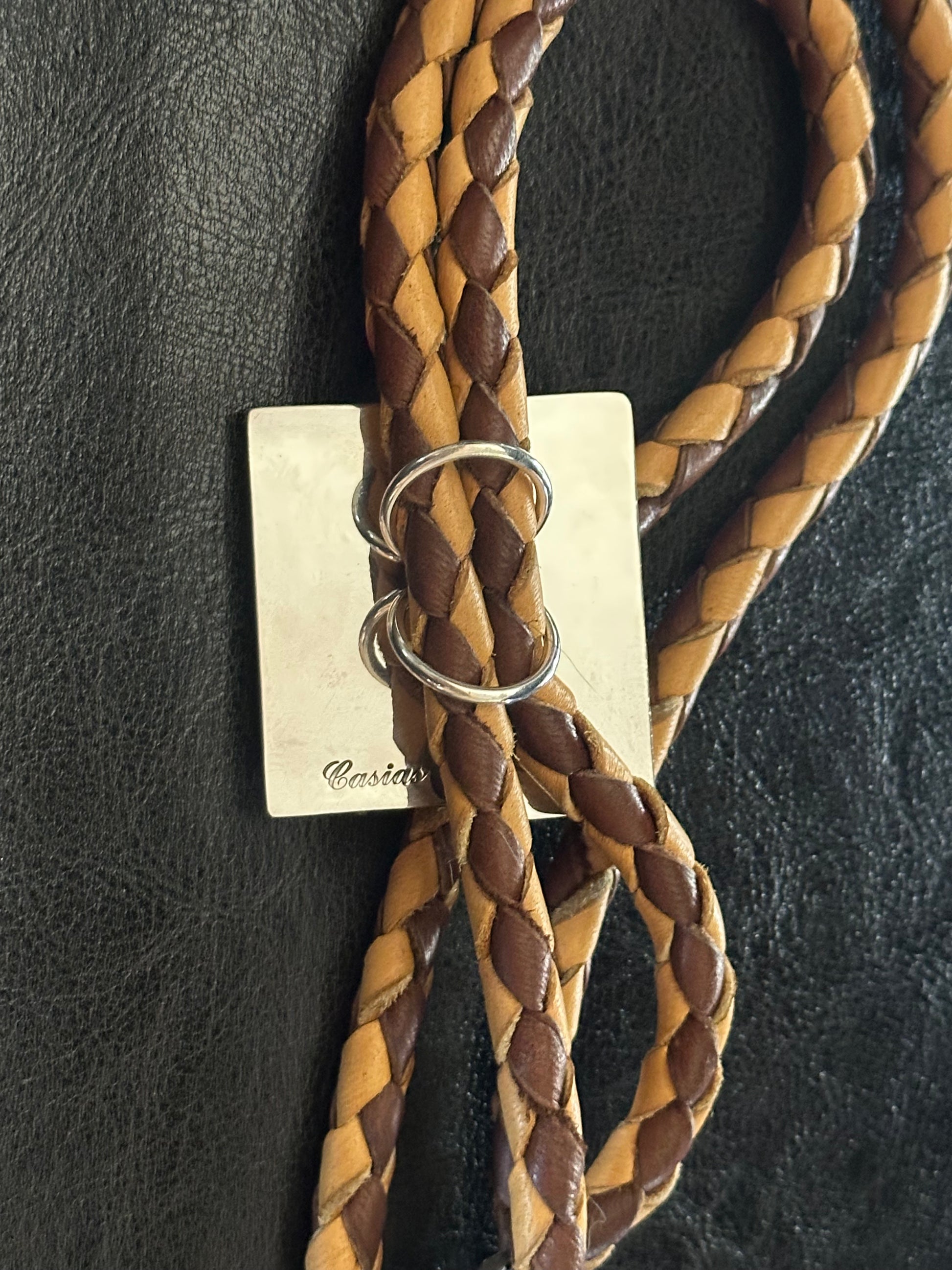 back view of Luxury Western bolo tie handmade by Shane Casias featuring sterling silver Zia pendant and vibrant red coral details